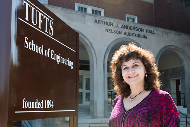 Karen Panetta stands in front of a Tufts University sign on campus.